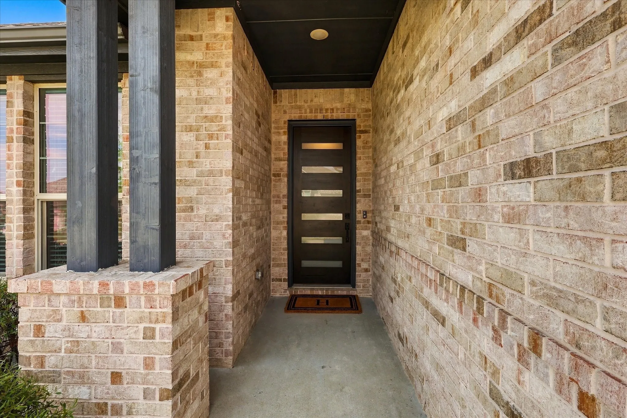 Walls of windows fill the main living and dining areas with natural light while the neutral palette and warm finishes create a comfortable, elevated atmosphere.
