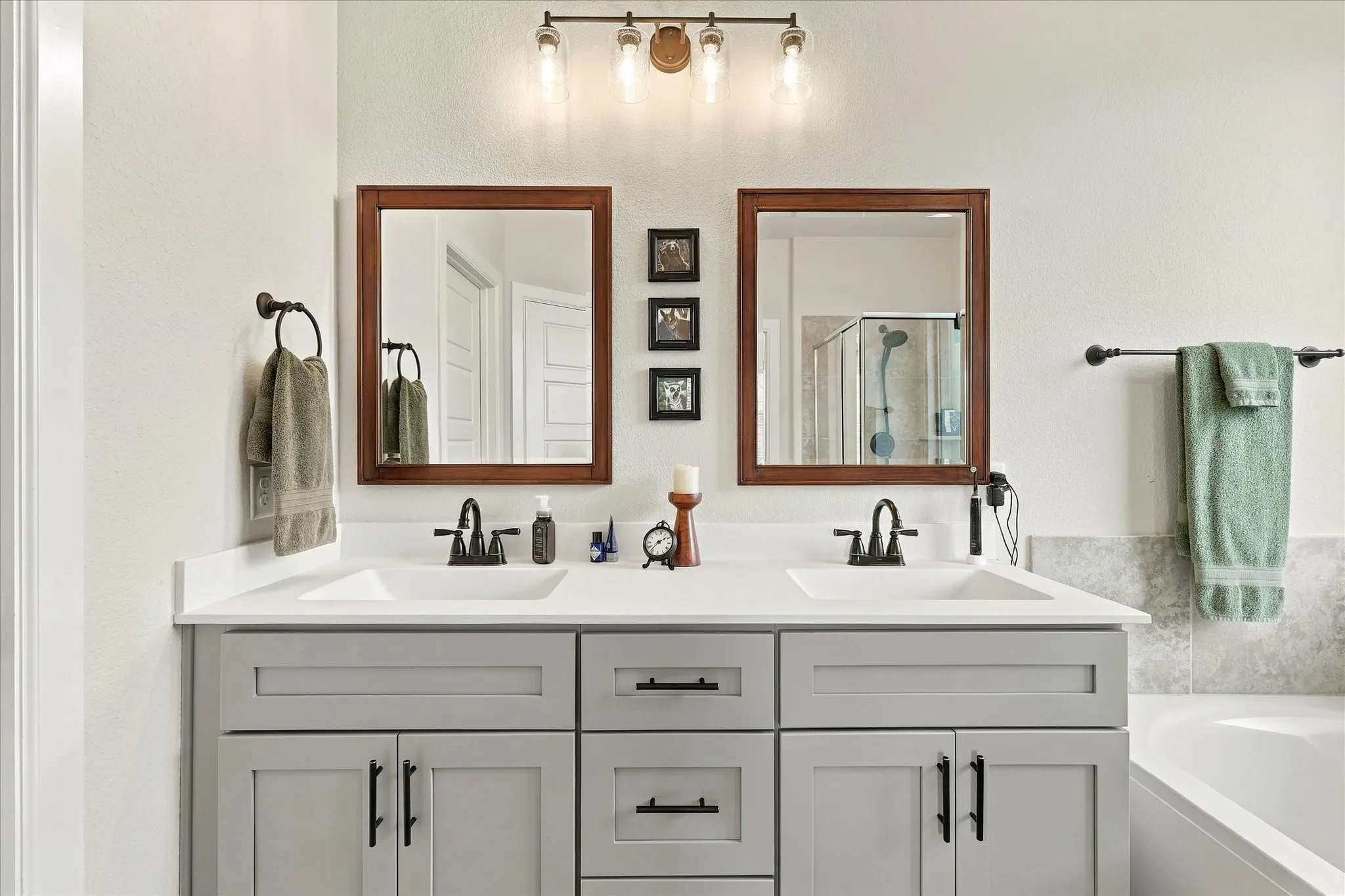 Clean lines, abundant cabinetry and dual sinks give the primary bath a polished, spacious and highly functional design.