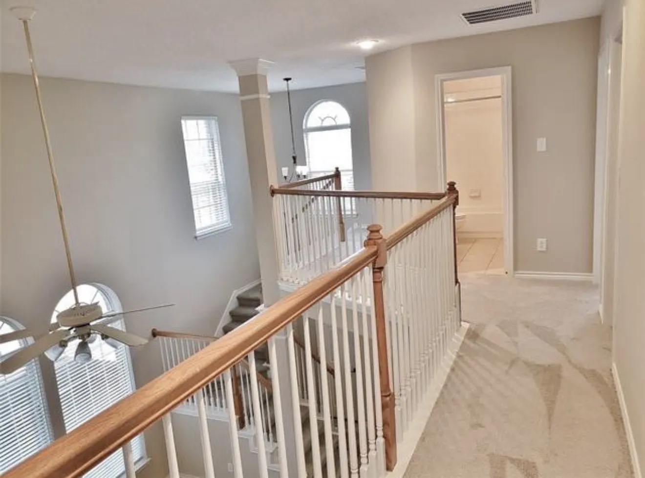Upper-level landing with carpeted flooring