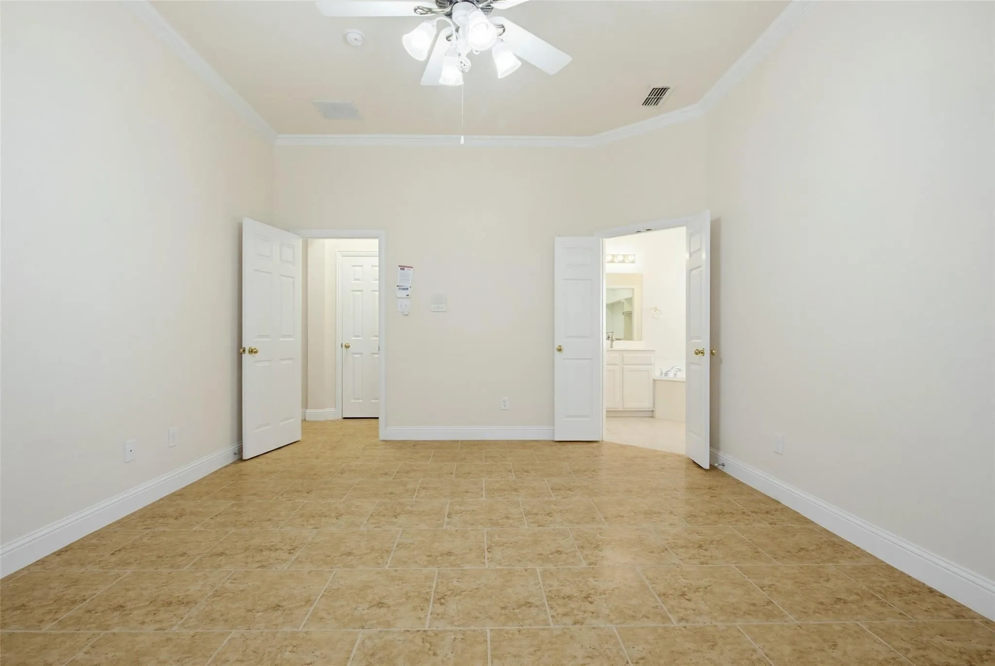Tiled flooring, crown molding, double doors, and a ceiling fan with integrated lighting