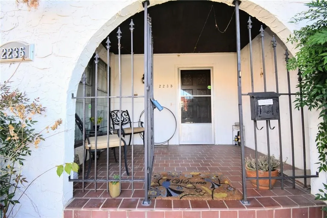 Arched entry featuring decorative wrought ironwork