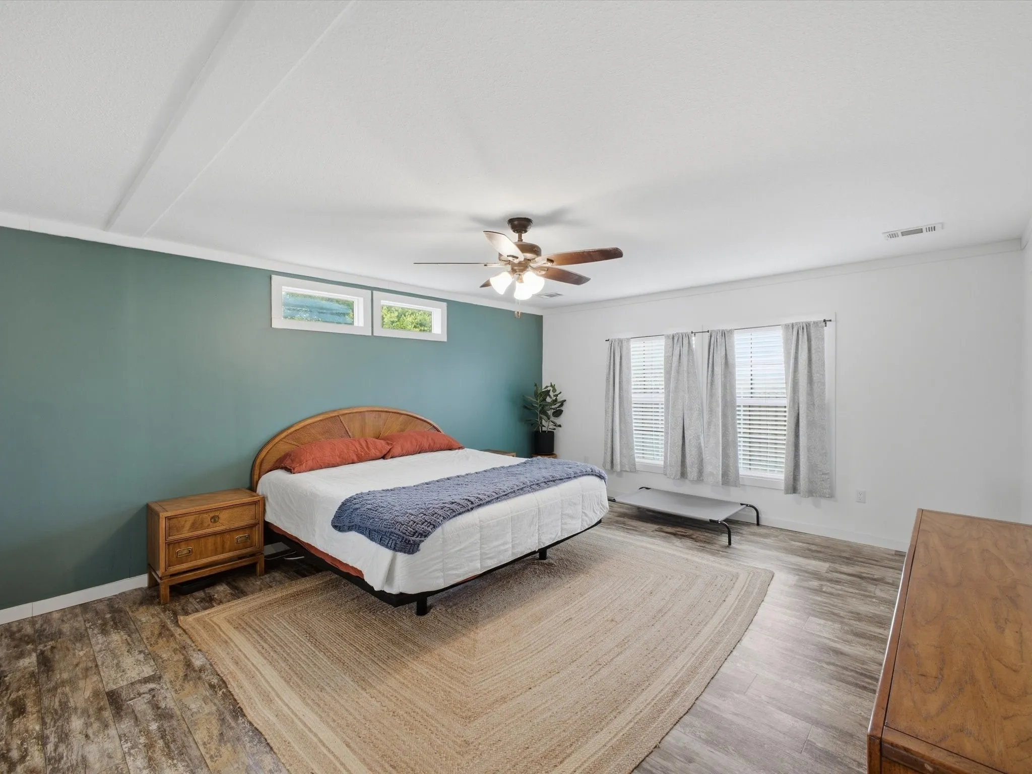 Wood-finish flooring throughout, complemented by a ceiling fan