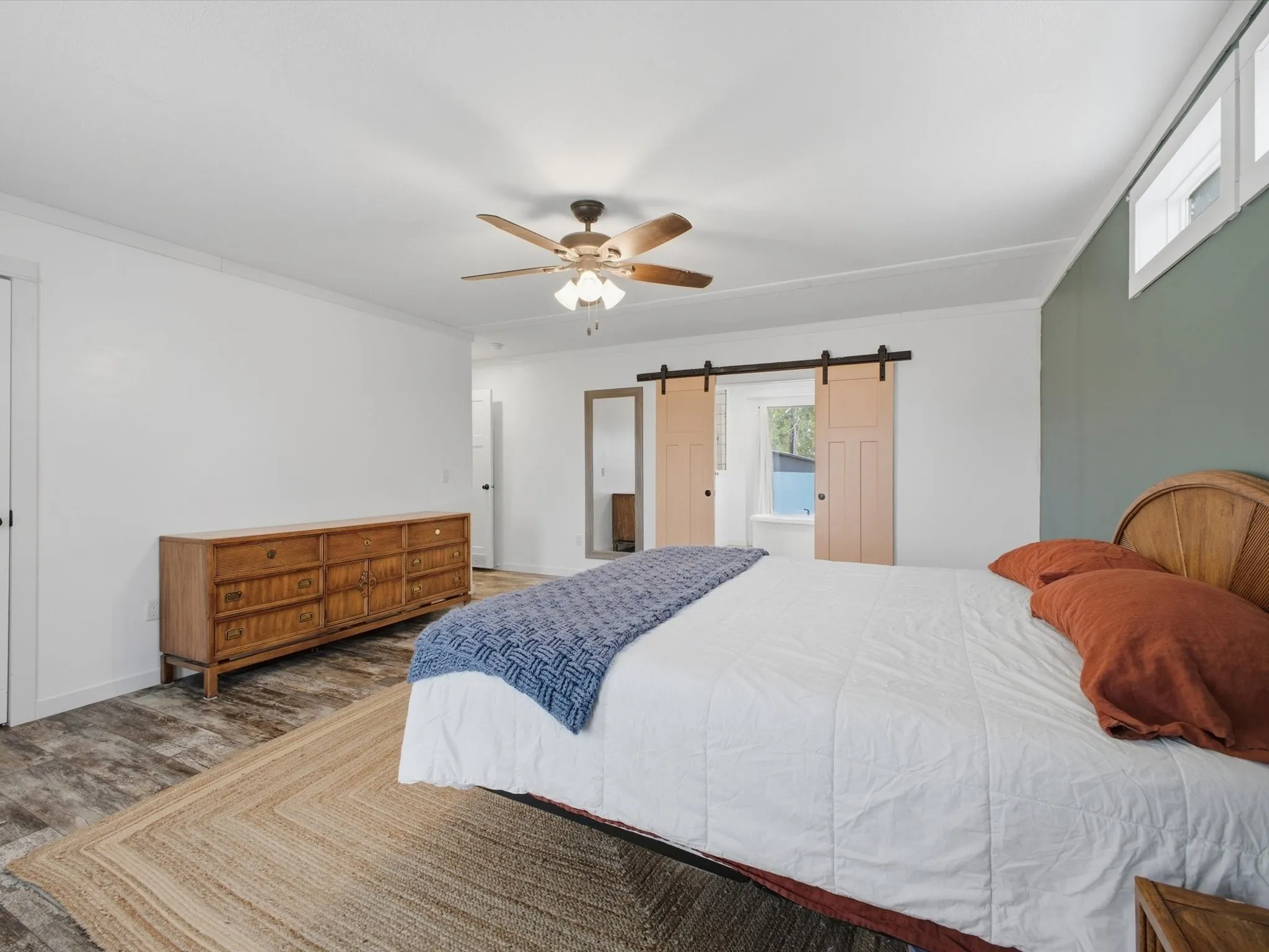 Wood-finish flooring, ceiling fan, and sliding barn doors