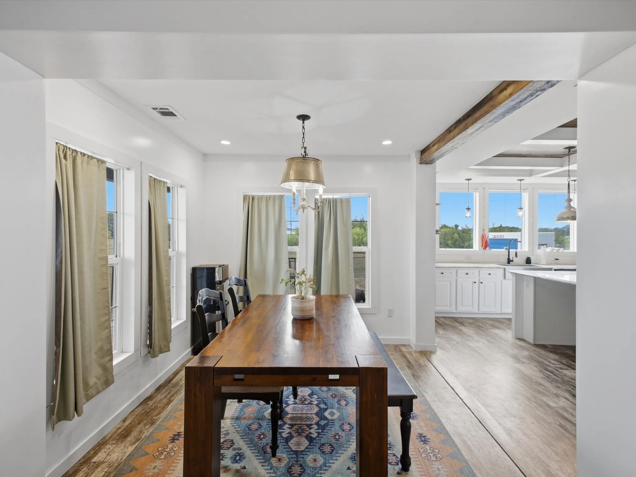 Dining area featuring wood-finish flooring, recessed lighting, and a decorative pendant light