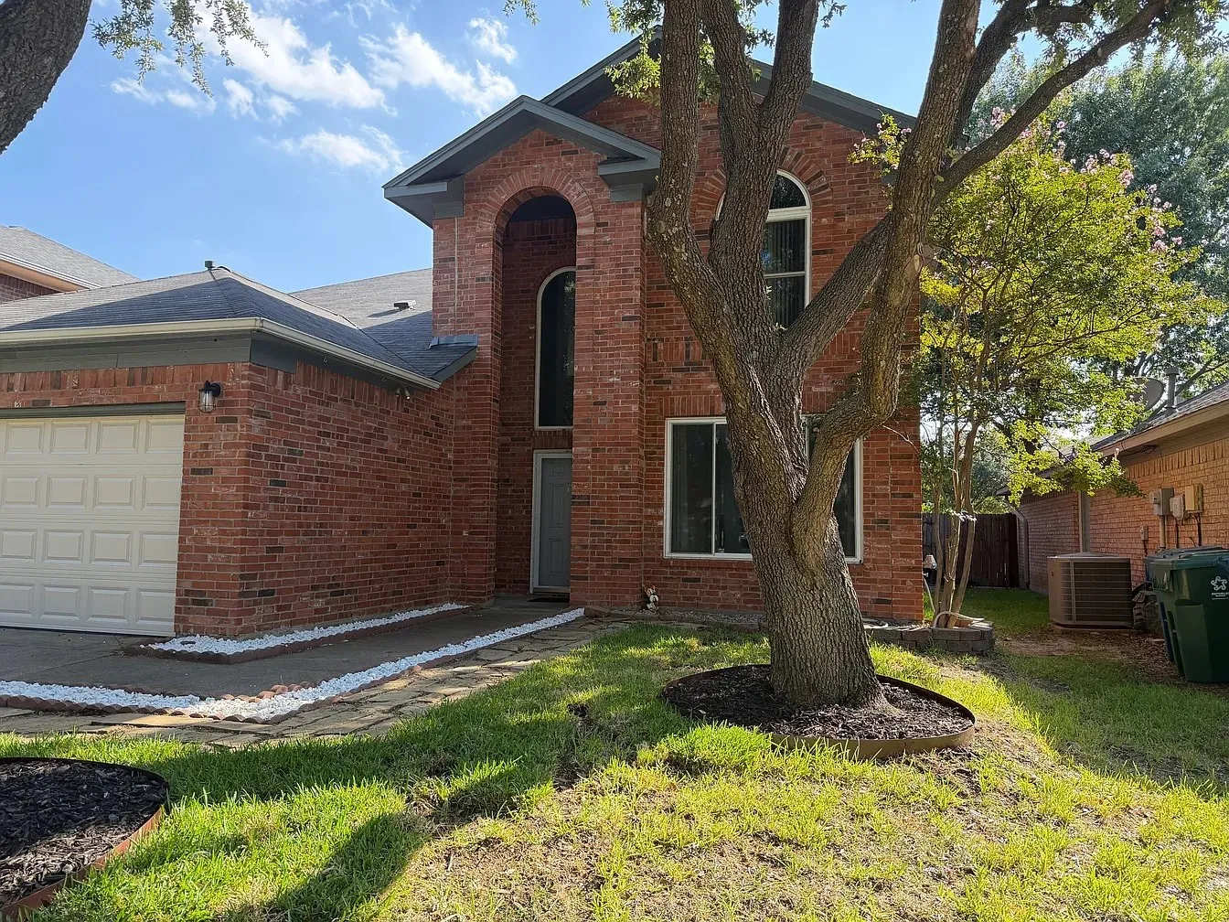 Brick exterior with an arched entryway and an arched window