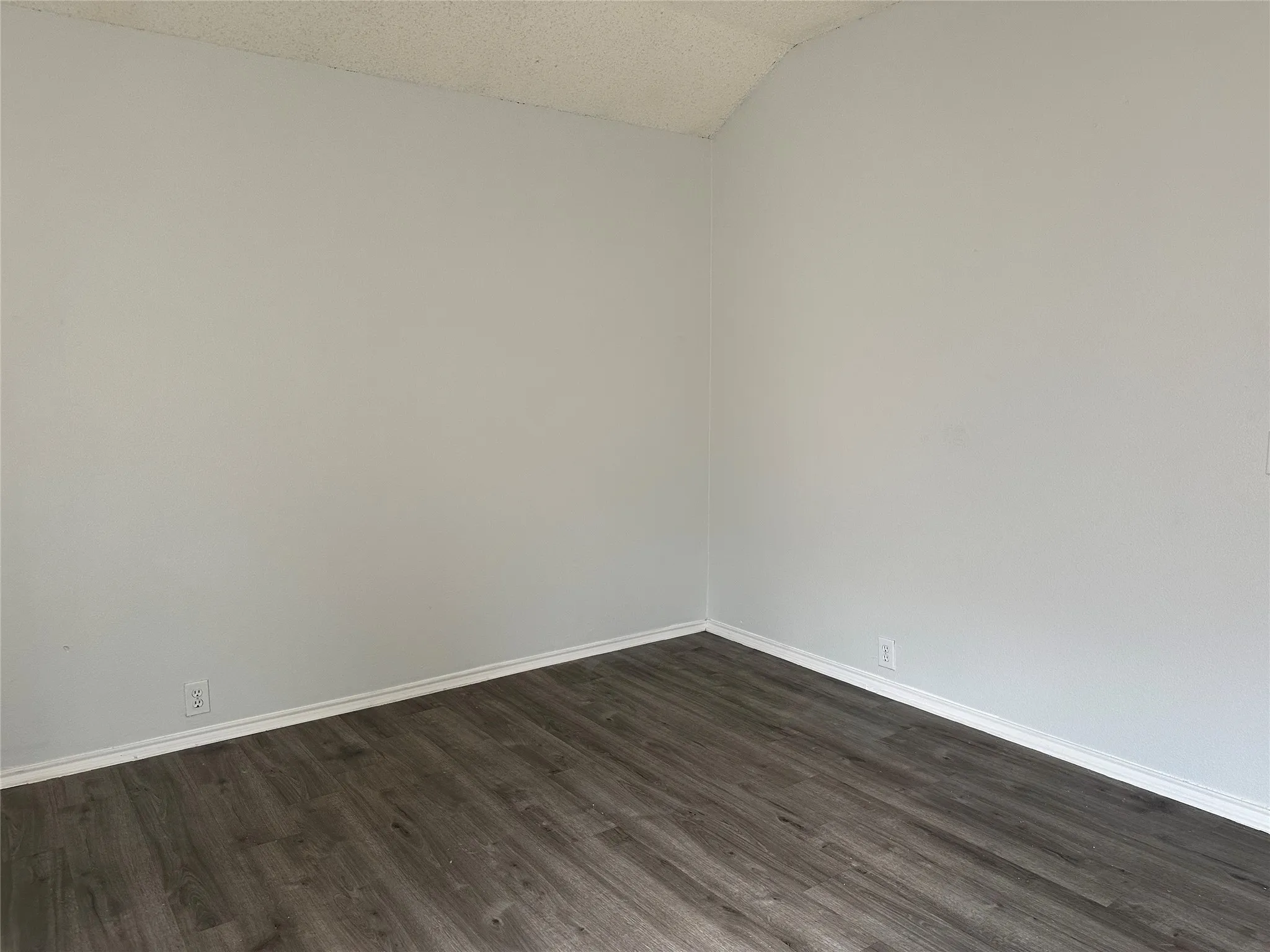 Dark wood-finish flooring with white trim