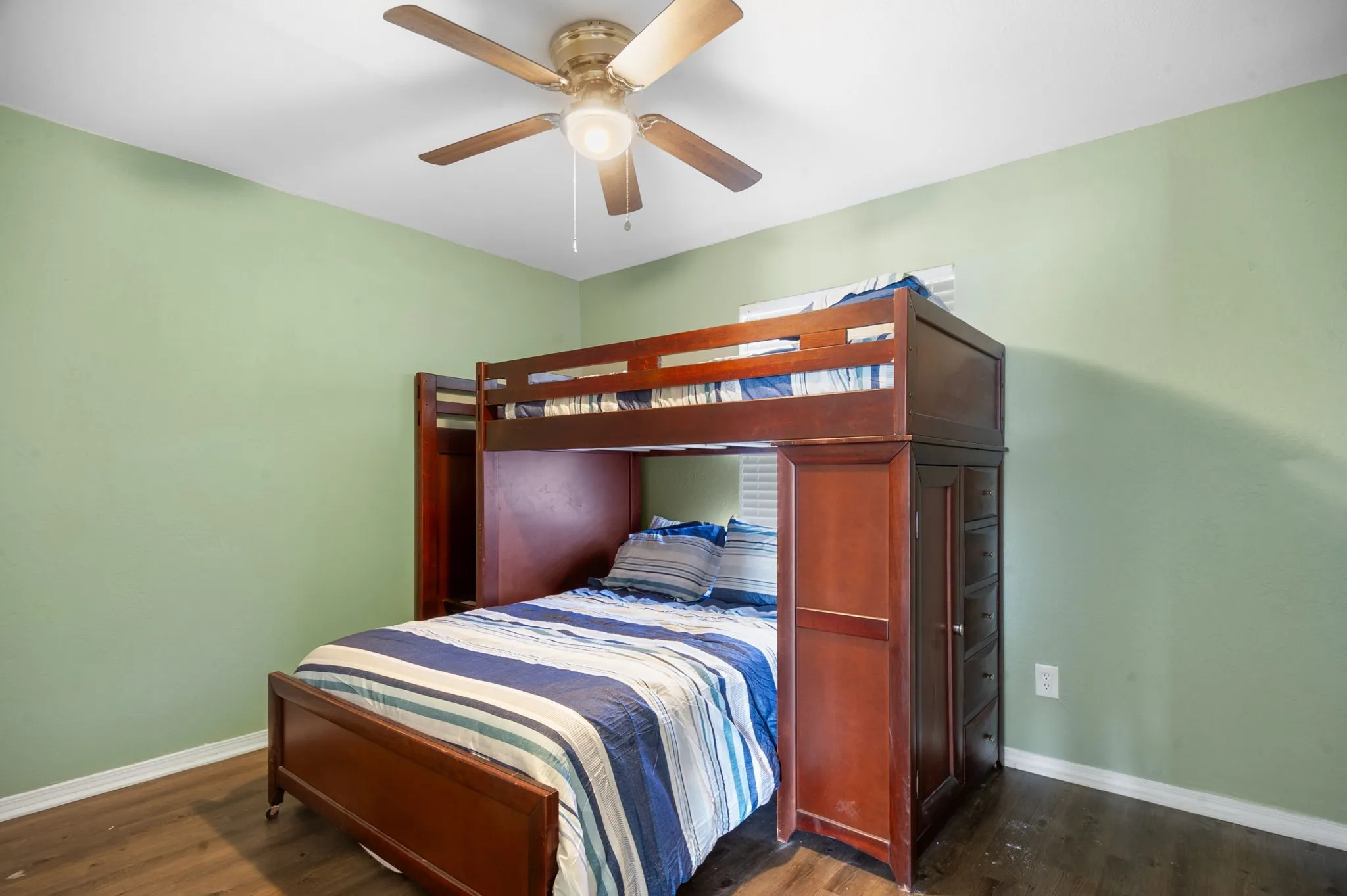Wood-finish flooring with light green wall color