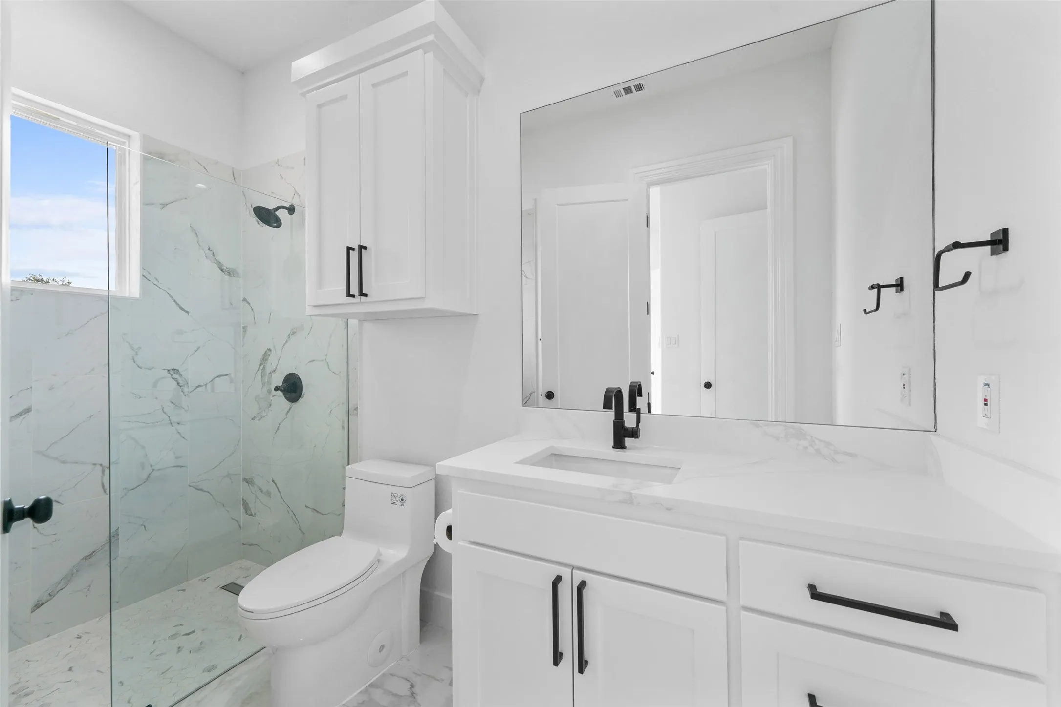 White vanity with integrated sink and quartz countertop