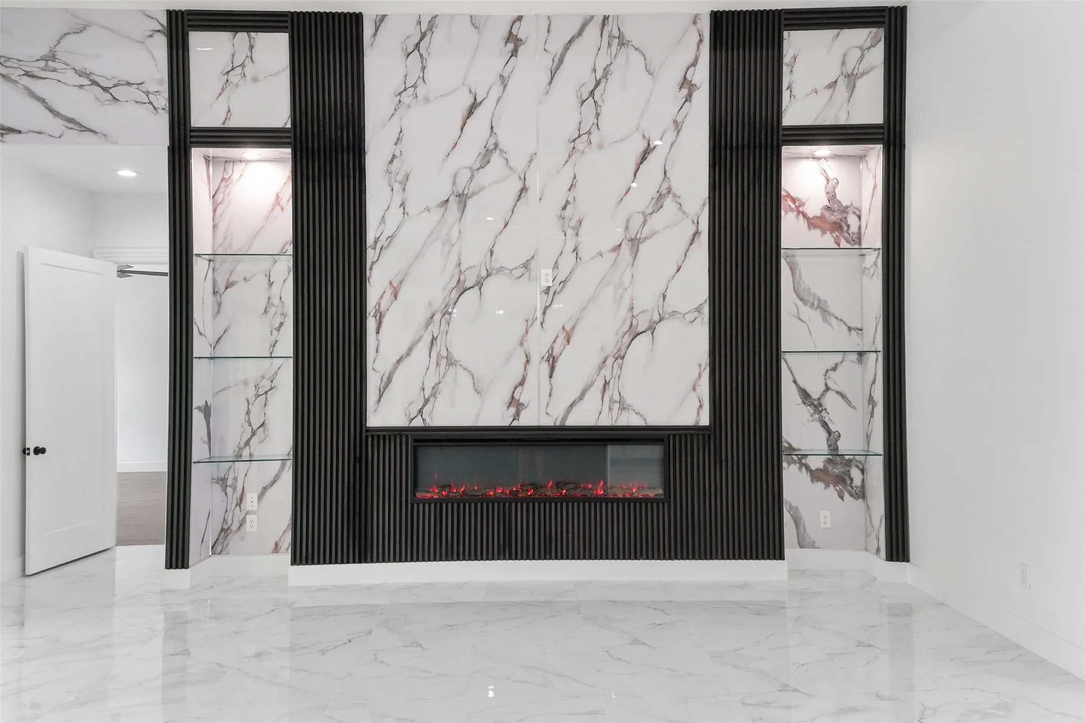 Feature wall with a built-in fireplace, marble-look paneling, and vertical slatted accents