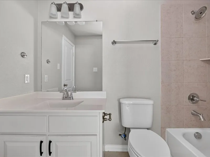 White vanity with undermount sink, chrome faucet, and integrated countertop