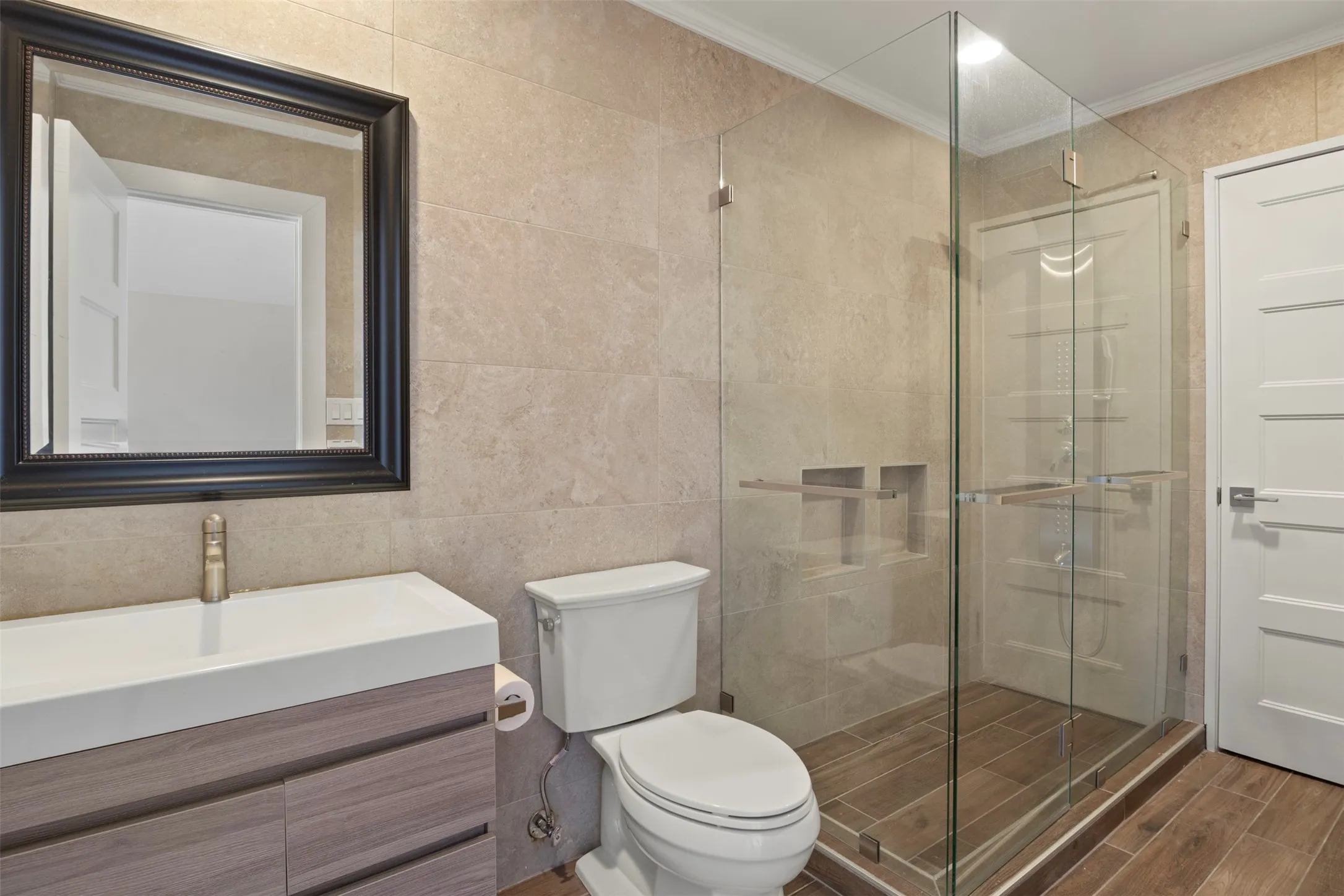 Frameless glass shower enclosure with built-in niches