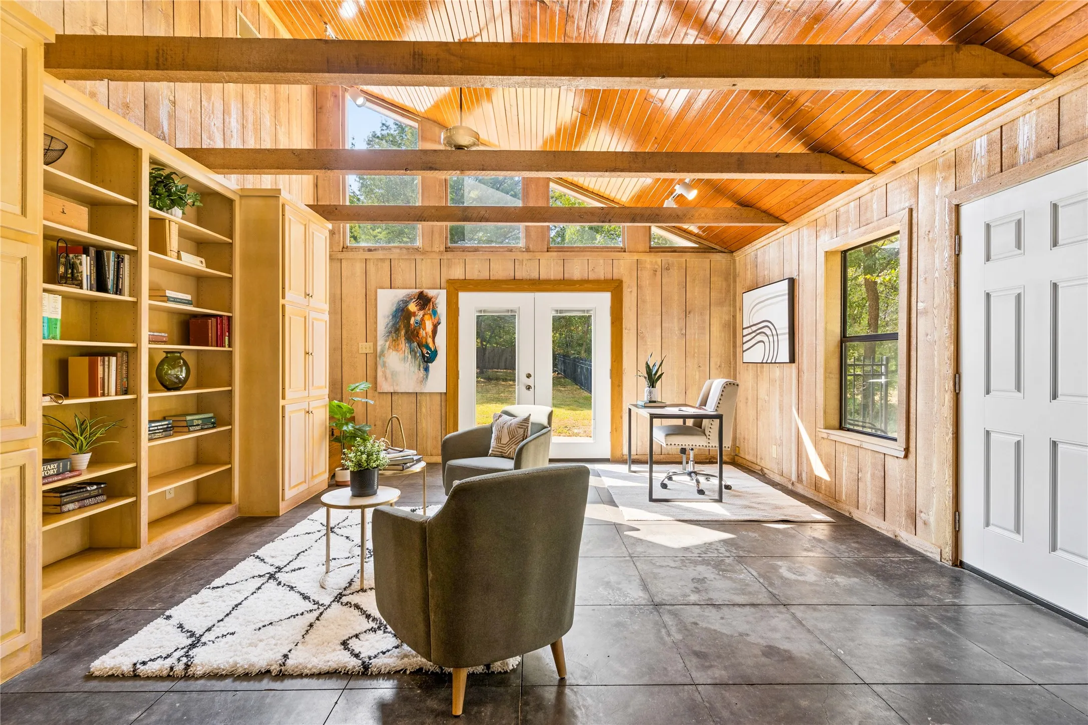 Climate controlled workshop with a half bath, sink, back patio, built-in cabinetry and connects directly to garage.