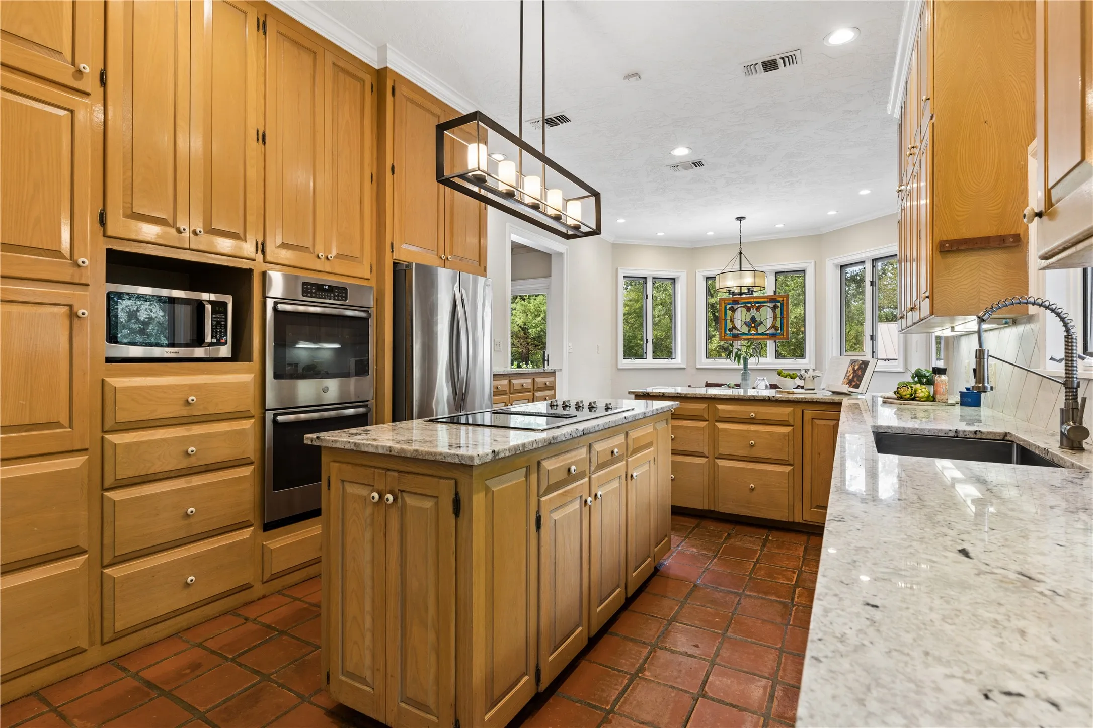 Gourmet kitchen has tons of counter space and cabinetry