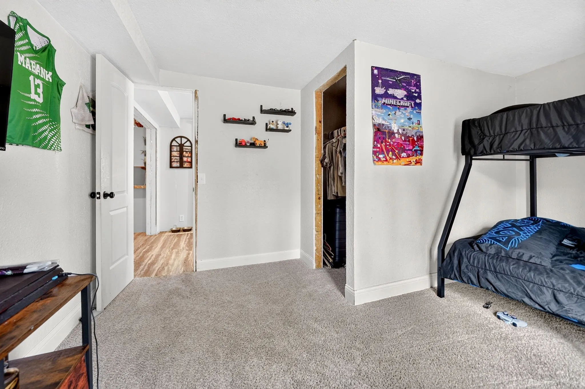 Light-toned carpet flooring and white walls