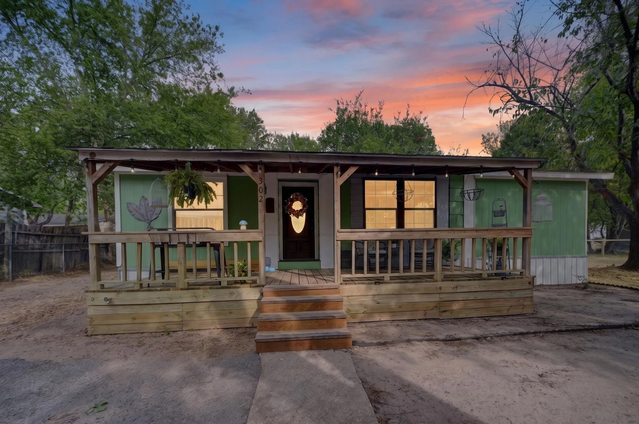 Covered porch with wood railing and steps