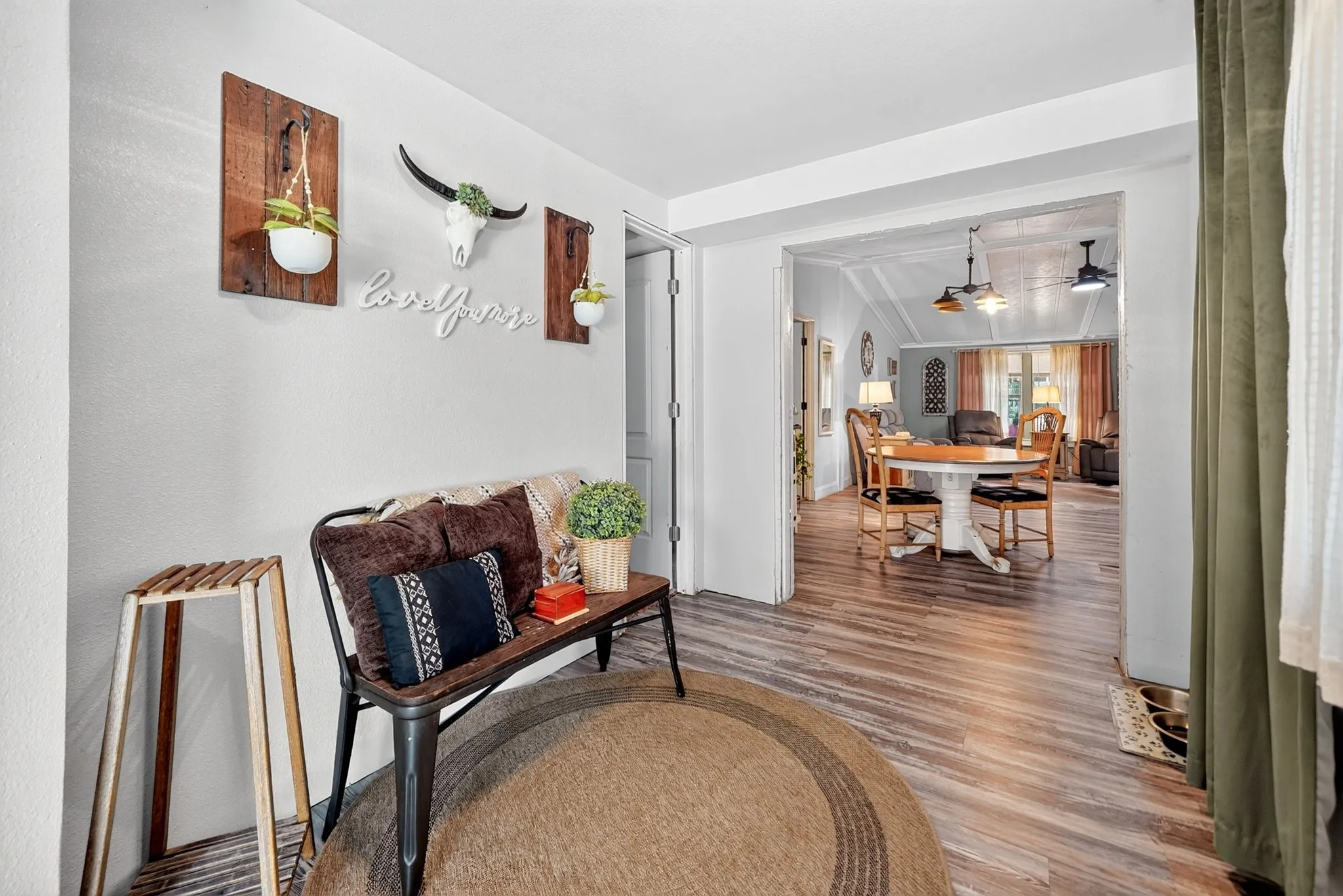 Entryway featuring wood-finish flooring and a broad doorway
