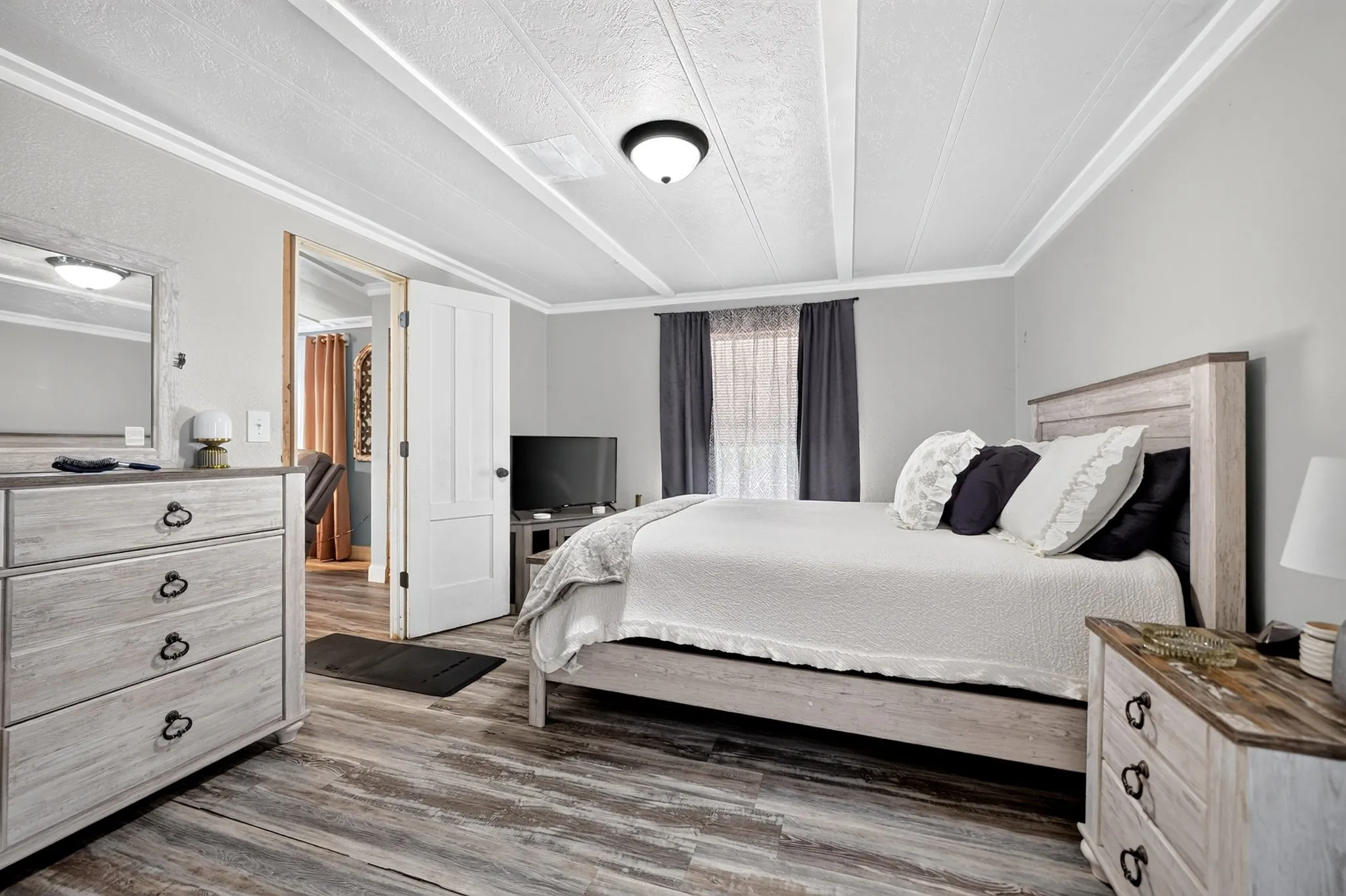 Wood-finish flooring, white paneled ceilings, and light gray wall paint