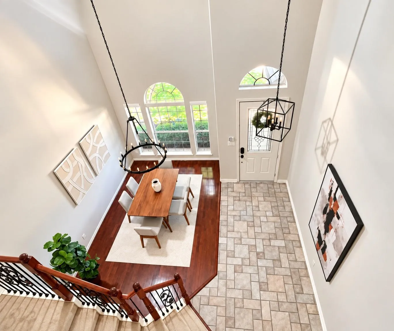 Two-story foyer with a vaulted ceiling, arch-top windows, and a decorative front door