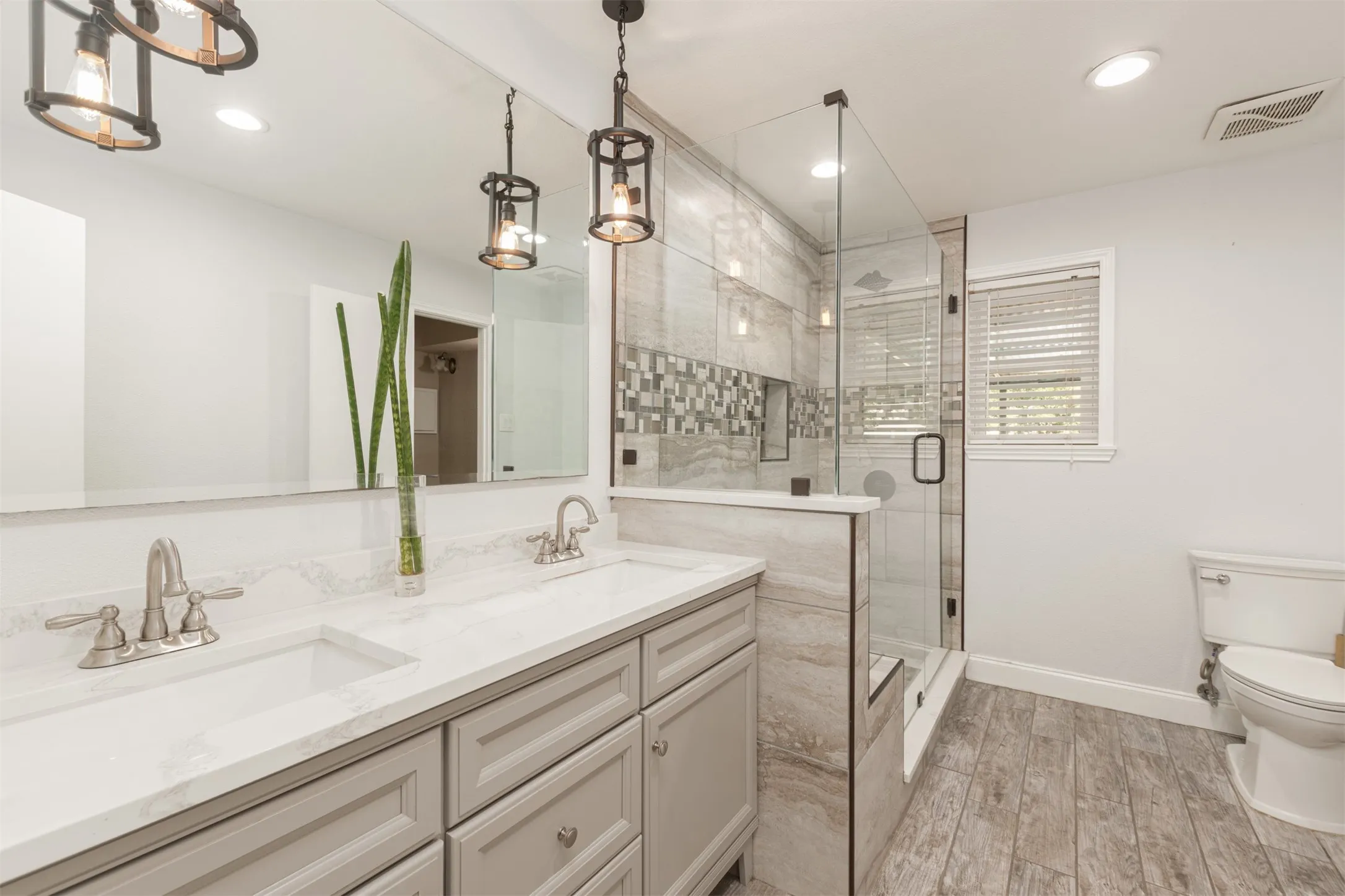 Dual vanity with white countertop and brushed nickel fixtures