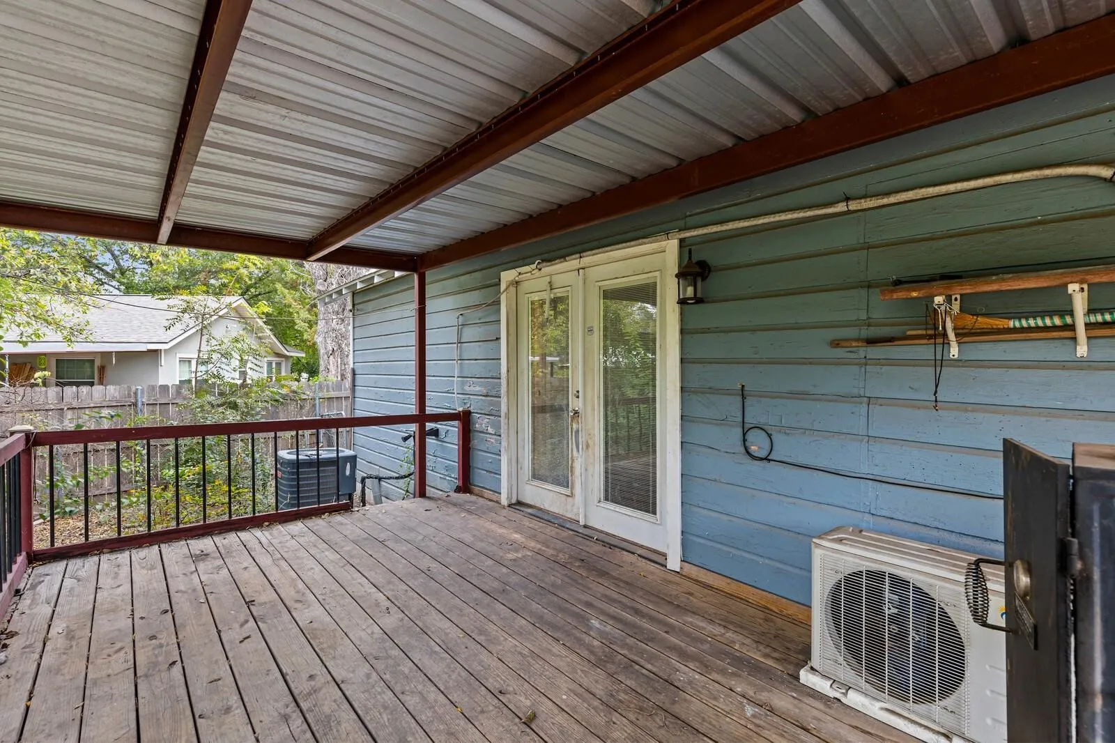 Expansive outdoor decking with dark wood railing and metal balusters