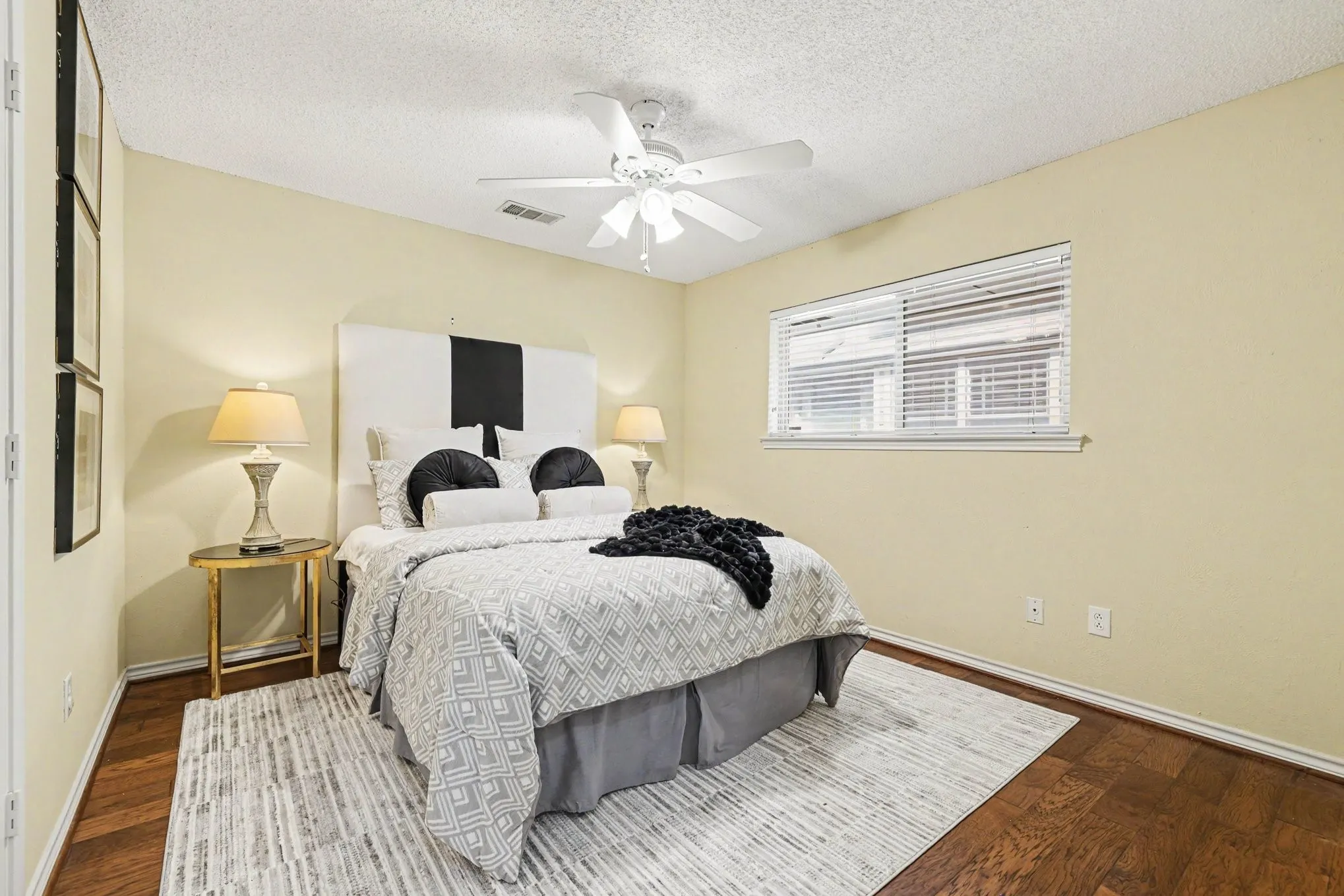 Wood-finish flooring, single window with blinds, ceiling fan, and light-toned walls