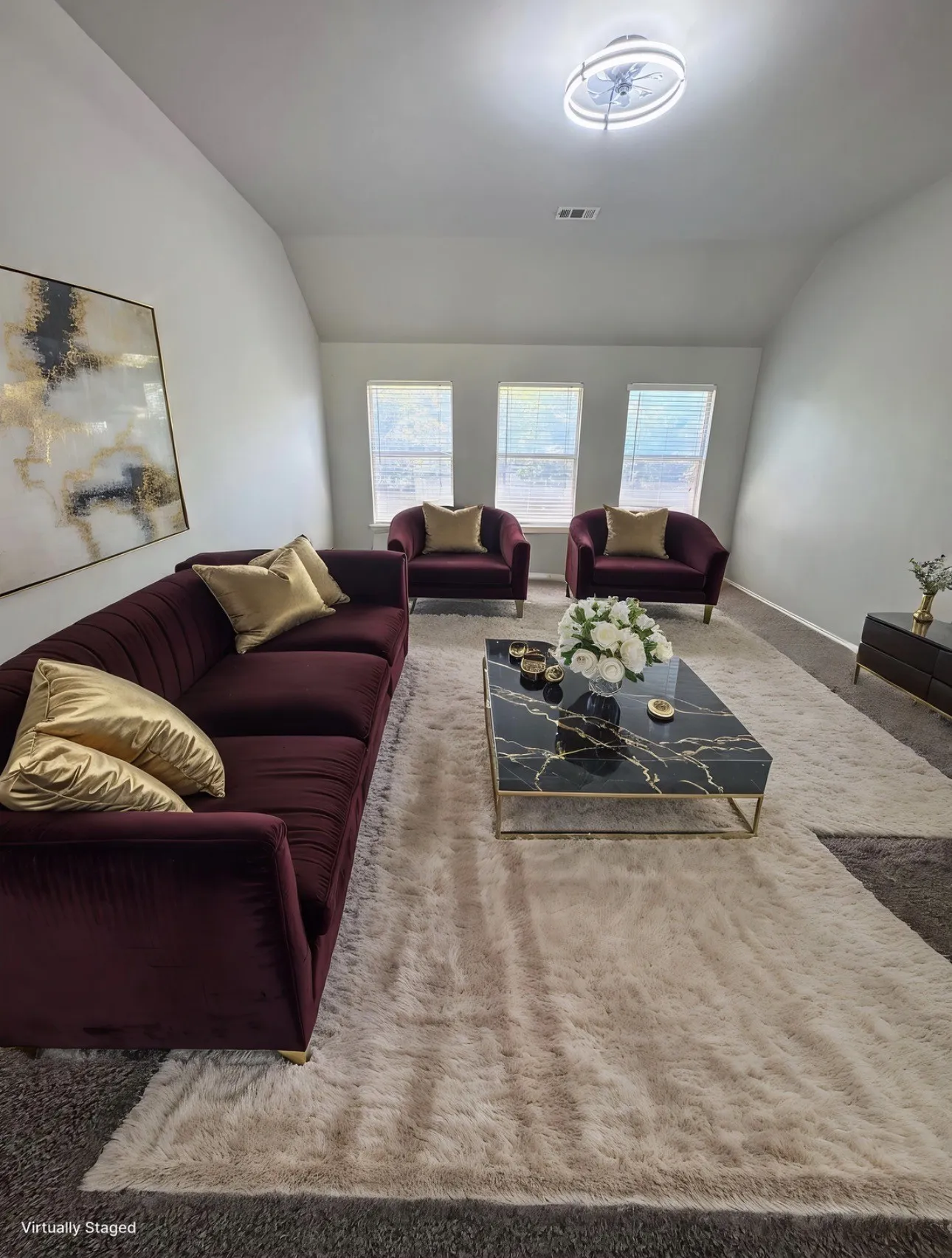 Living area with carpet floors and vaulted ceiling