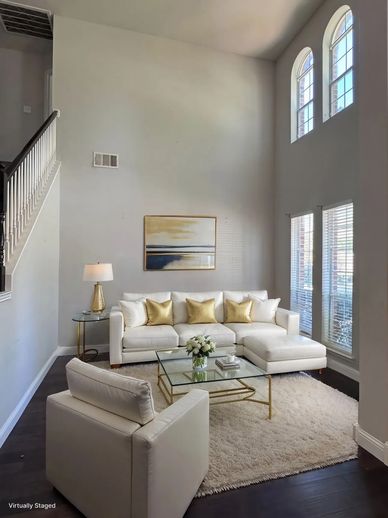 Living area or home office with a high ceiling, dark wood-style flooring, and healthy amount of natural light