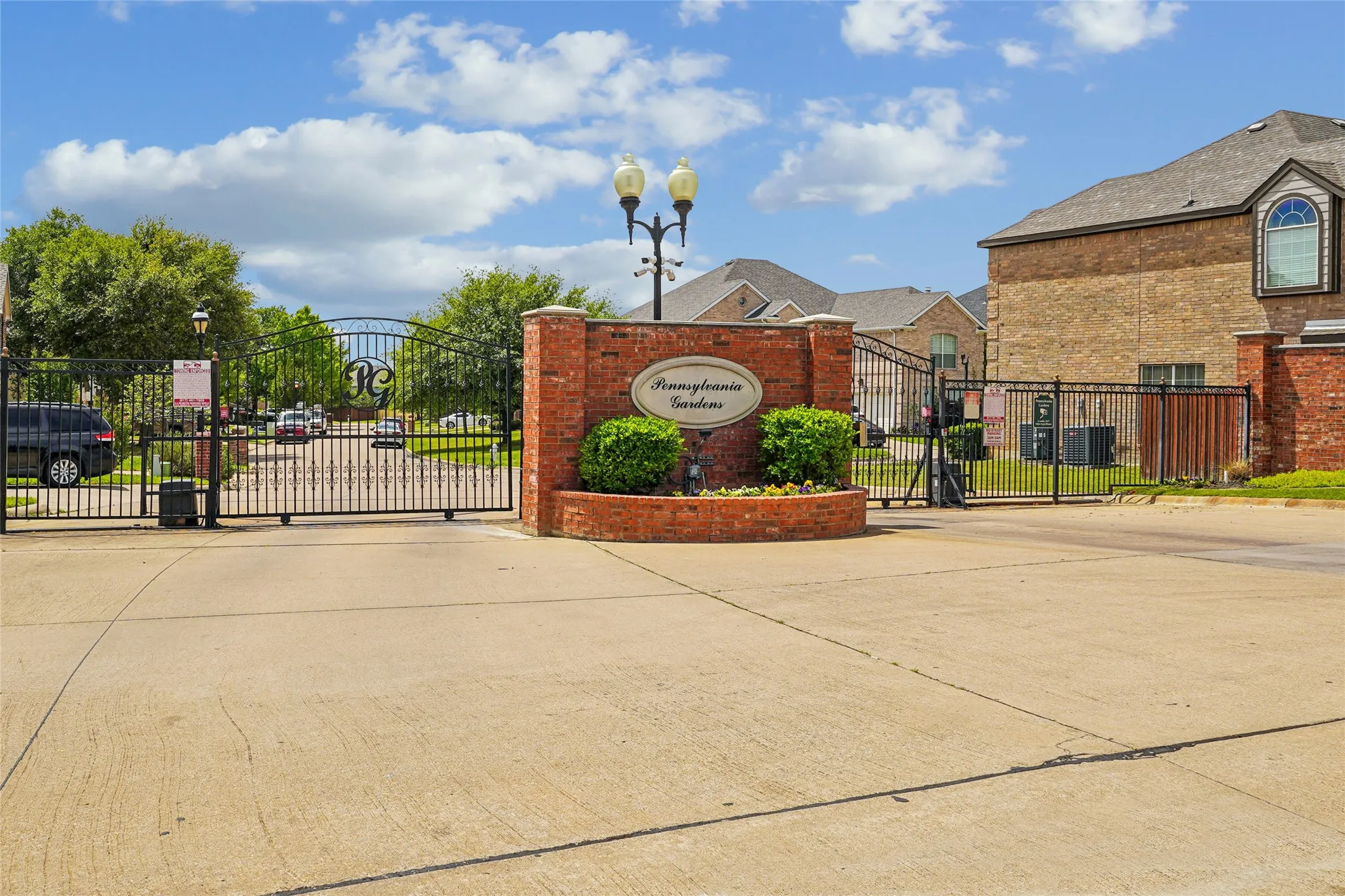 Community / neighborhood sign featuring a gate