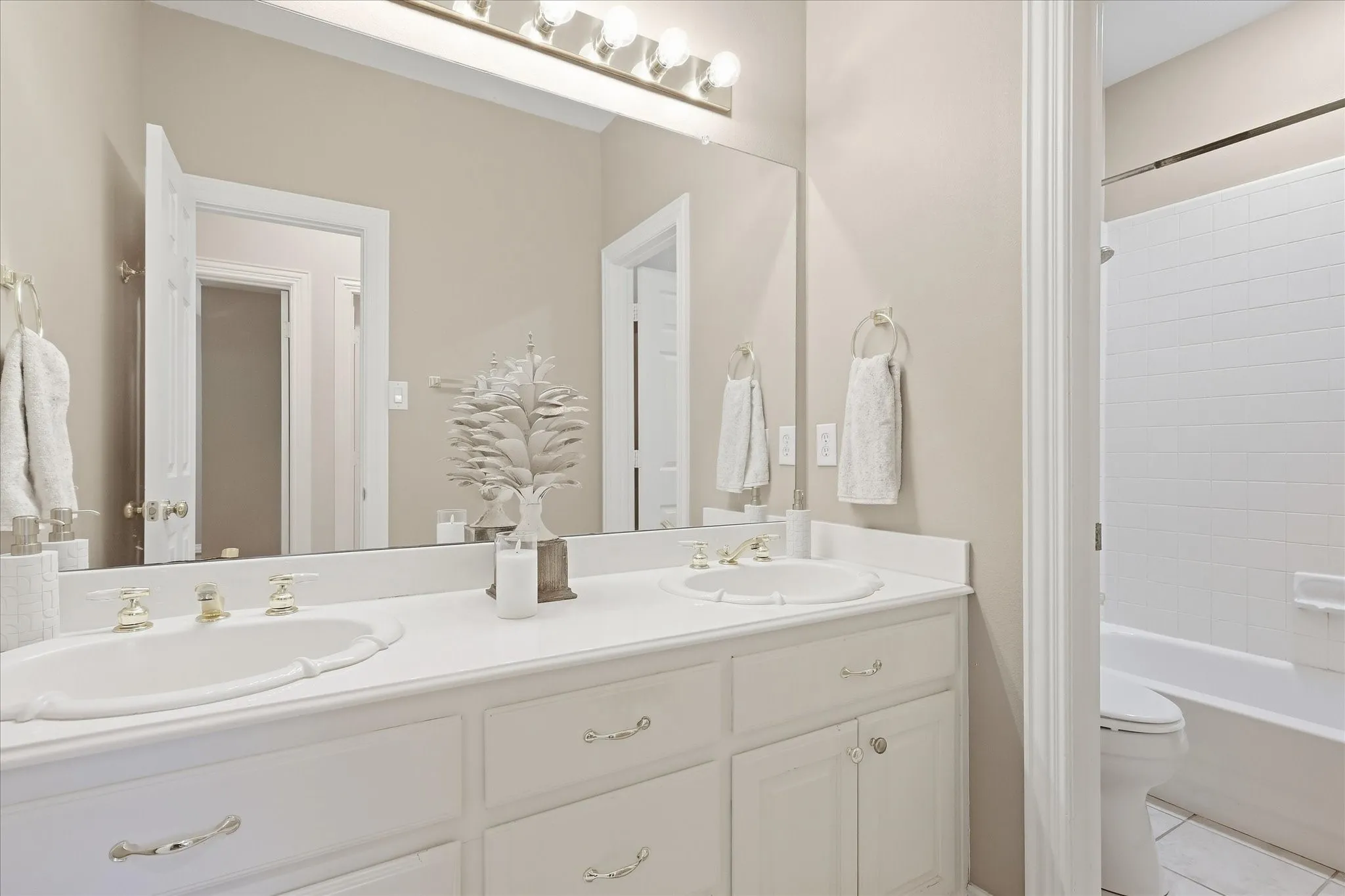 Spacious Secondary Bathroom with Two Sinks & Separately Enclosed Shower Area