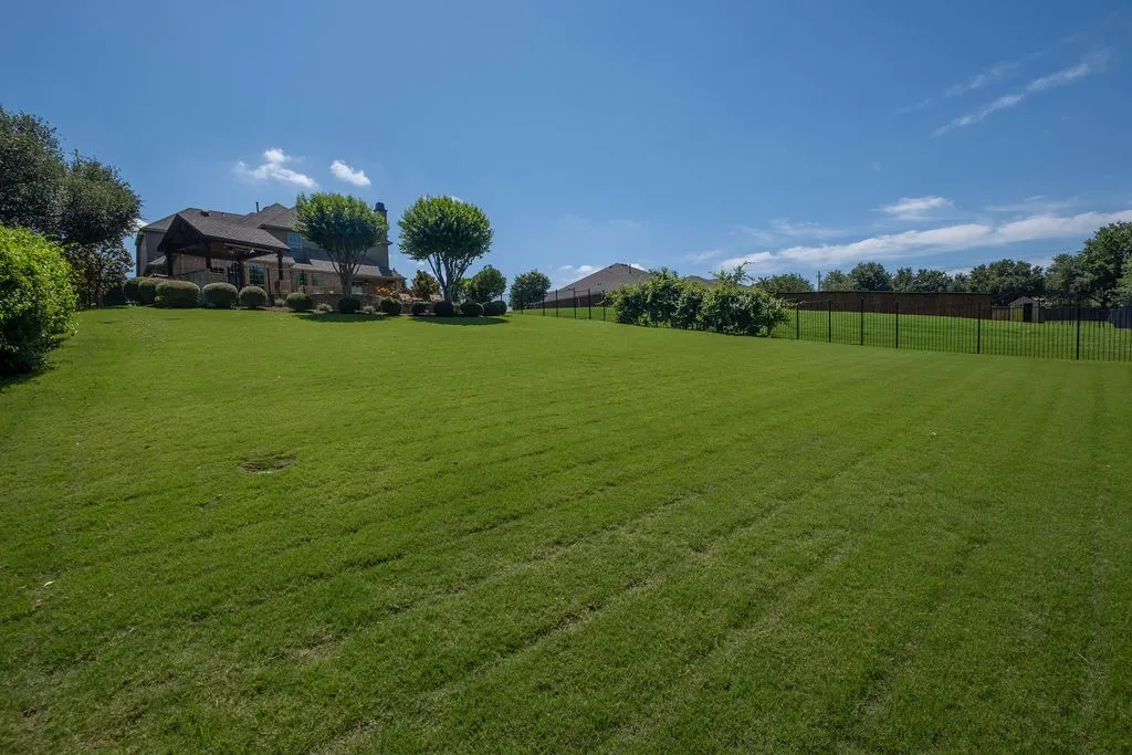 Expansive ,back yard, fully fenced, sits on the plush greenbelt.