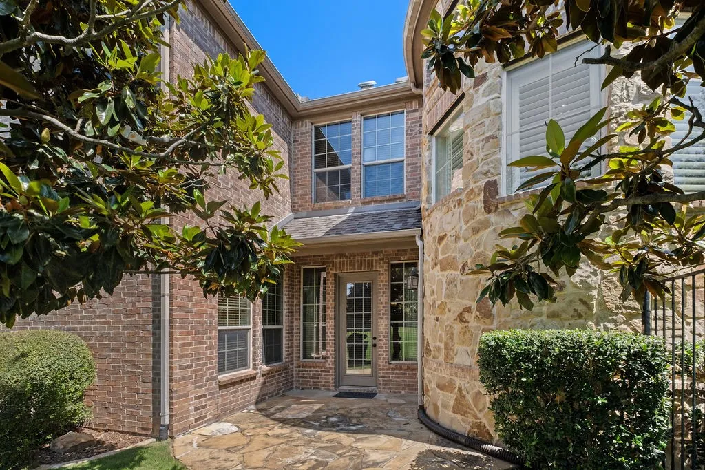 Side courtyard, featuring beautiful magnolias, the perfect place for morning coffee. Underground drainage, leading the water away from the home.