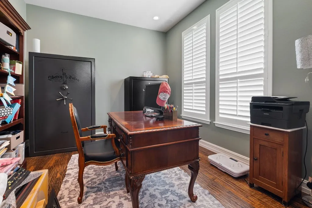 Hardwood flooring, painted walls, two windows with white plantation shutters, and recessed ceiling lighting
