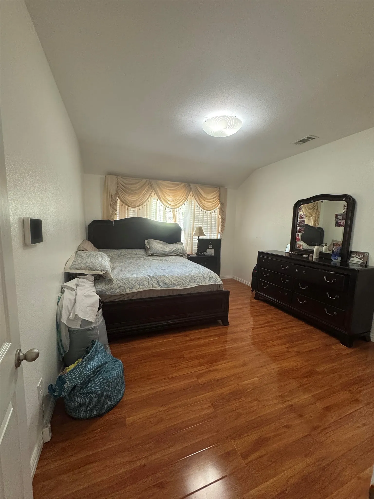 Wood-finish flooring with a ceiling-mounted light fixture
