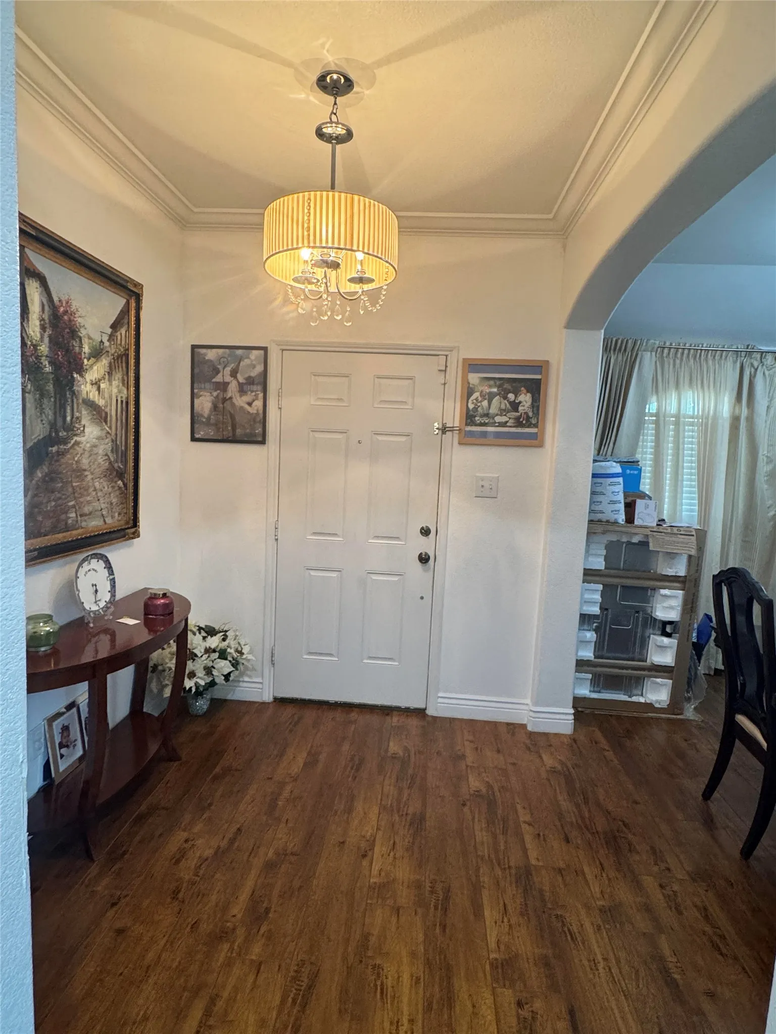 Wood-finish flooring throughout, complemented by crown molding and baseboards