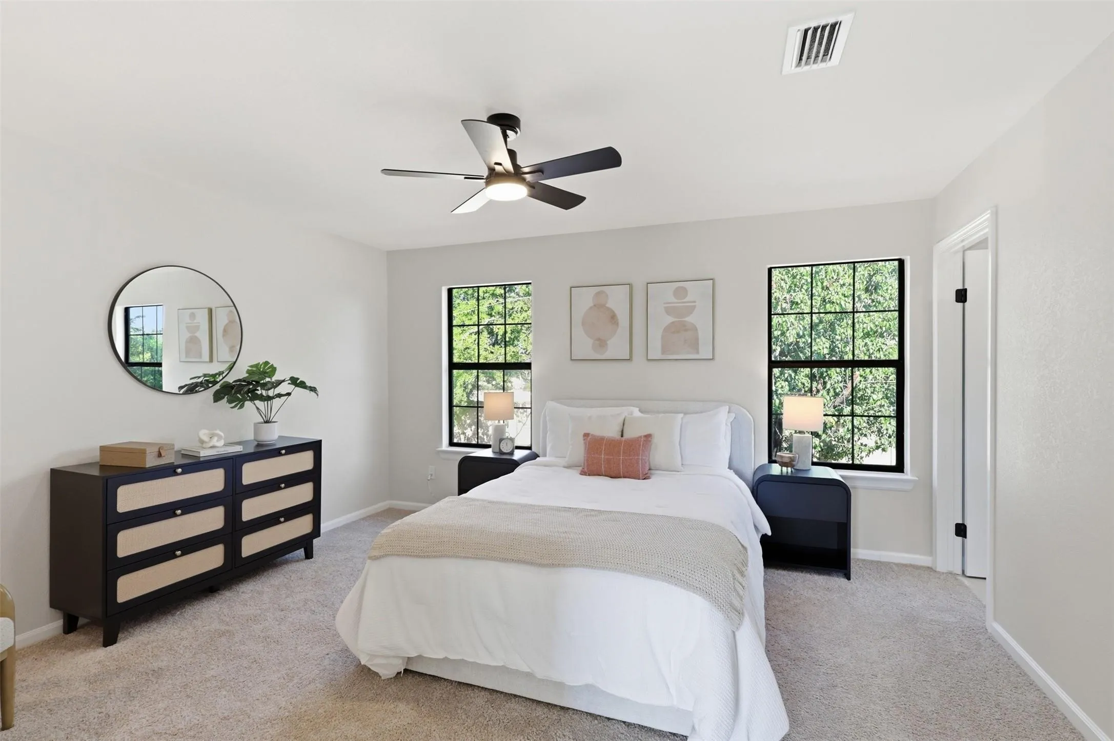 Carpeted flooring, contemporary ceiling fan with integrated lighting, and dual window openings