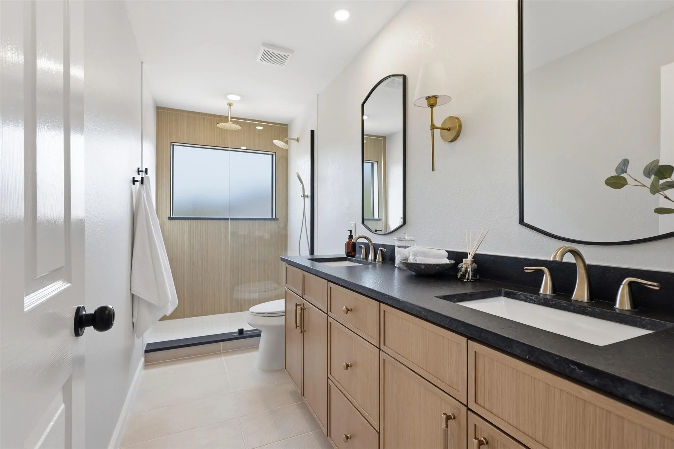 Dual vanity with a dark countertop and integrated sinks
