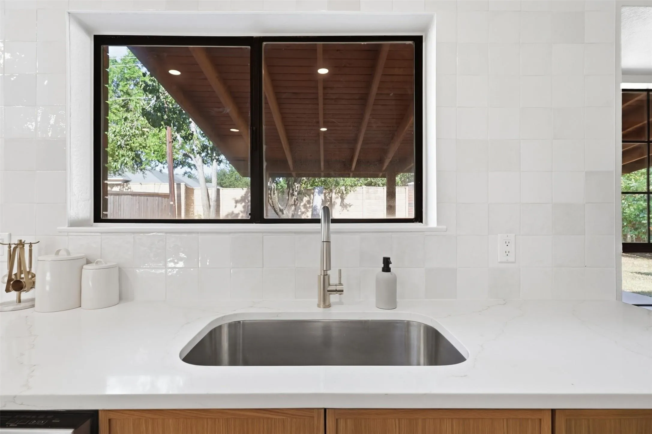 Stainless steel undermount sink with a brushed nickel faucet, set in a light-toned countertop