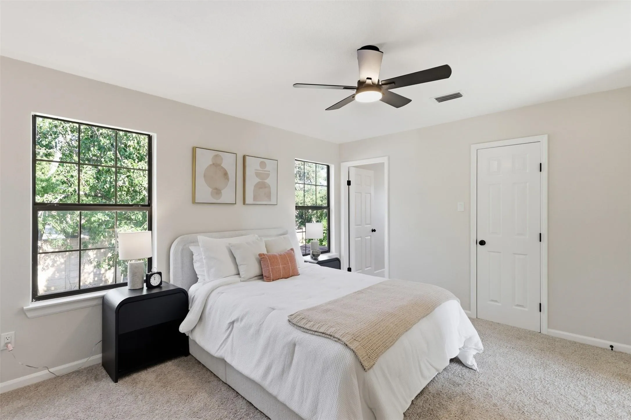 Recessed lighting, ceiling fan with integrated lighting, two windows with gridded panes, light neutral wall color, and carpeted flooring