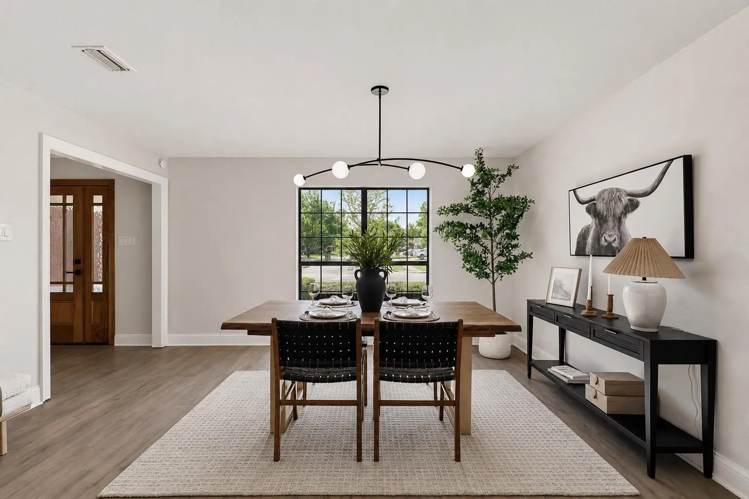 Wood-finish flooring, recessed lighting, and a modern chandelier