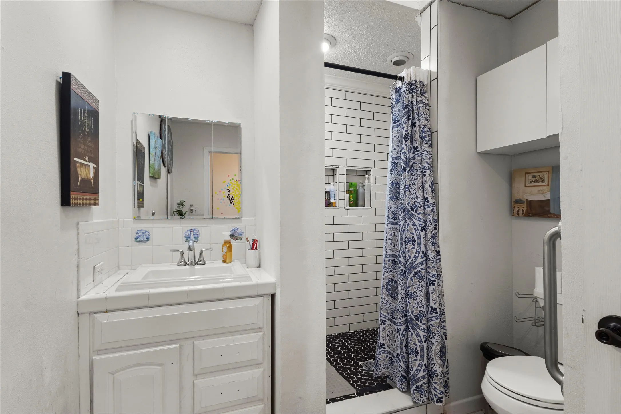 White tiled vanity with integrated sink and chrome faucet