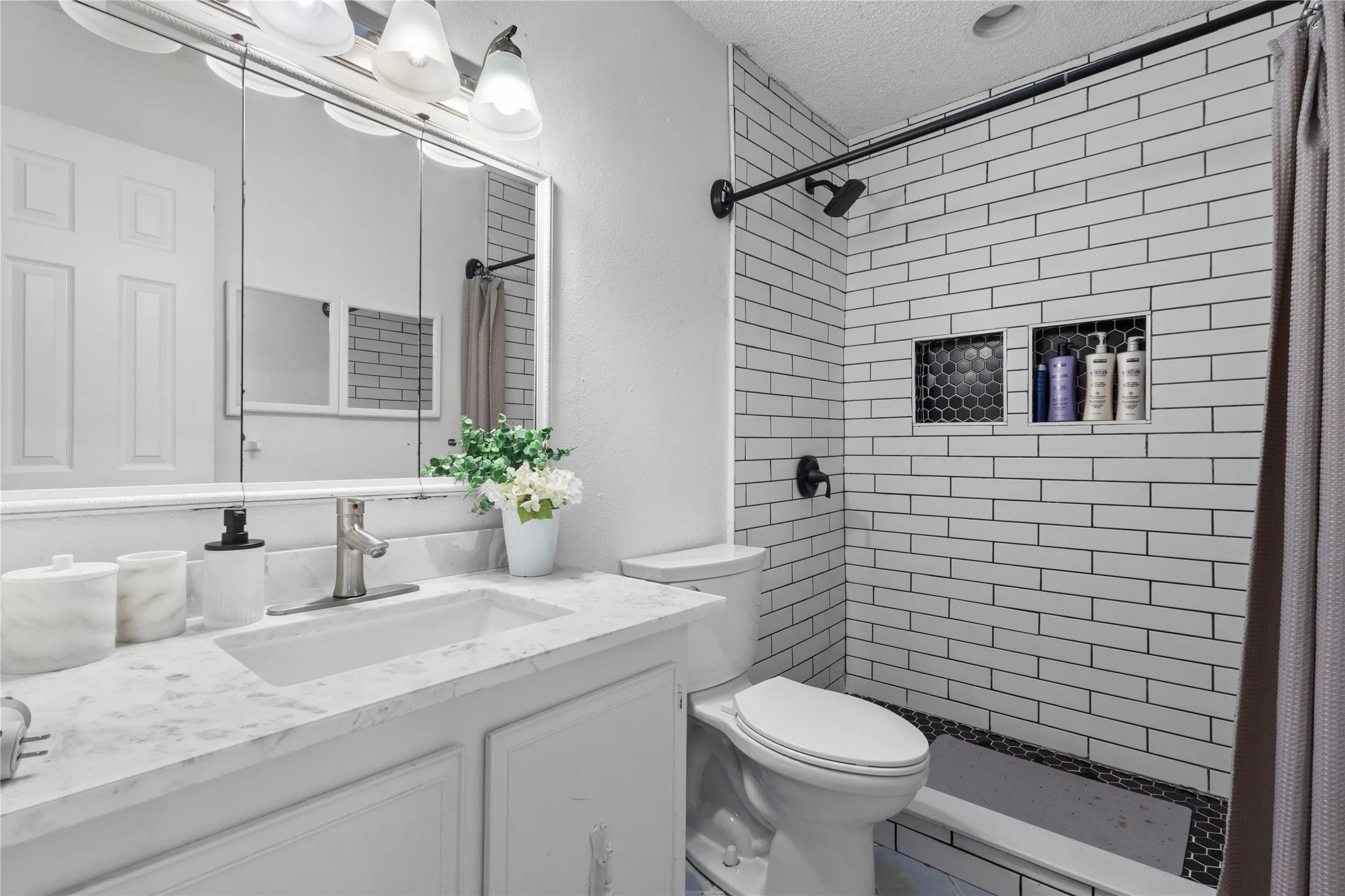 Integrated white vanity with a rectangular sink and brushed nickel faucet