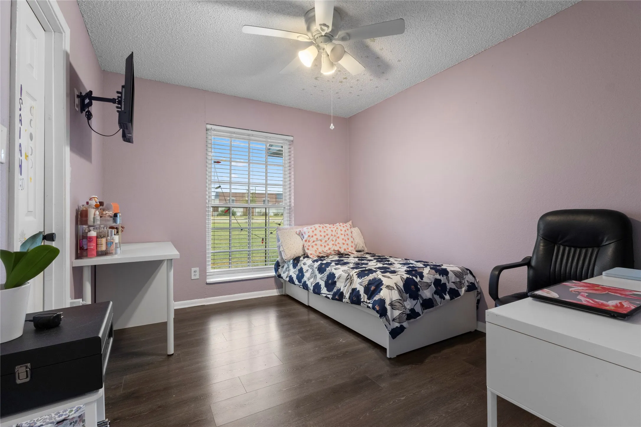 Wood-finish flooring with a window featuring blinds, a ceiling fan, and painted walls