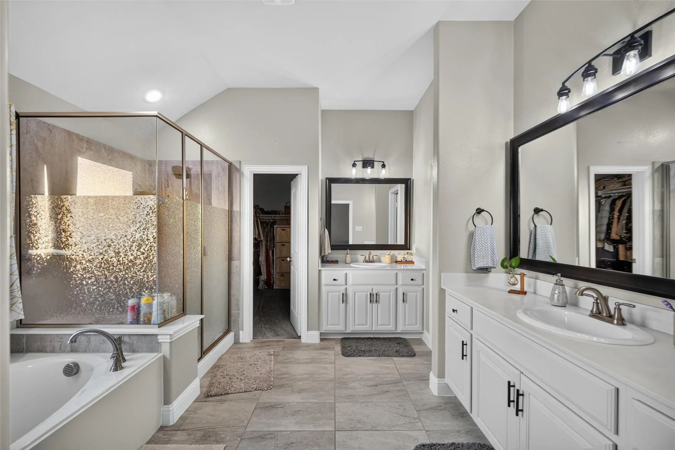 Dual vanity with white cabinetry and integrated sinks