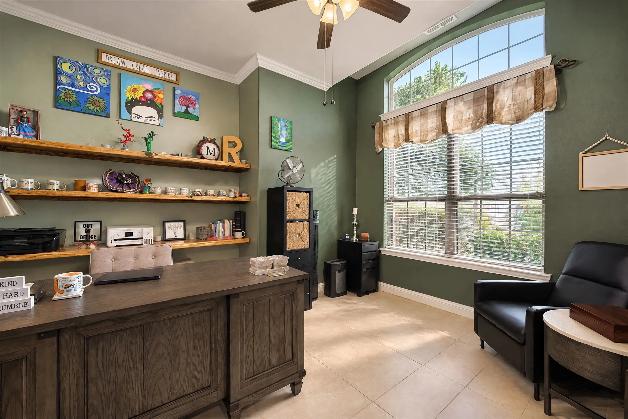 Tiled flooring, vaulted ceiling, and a large arched window with horizontal blinds