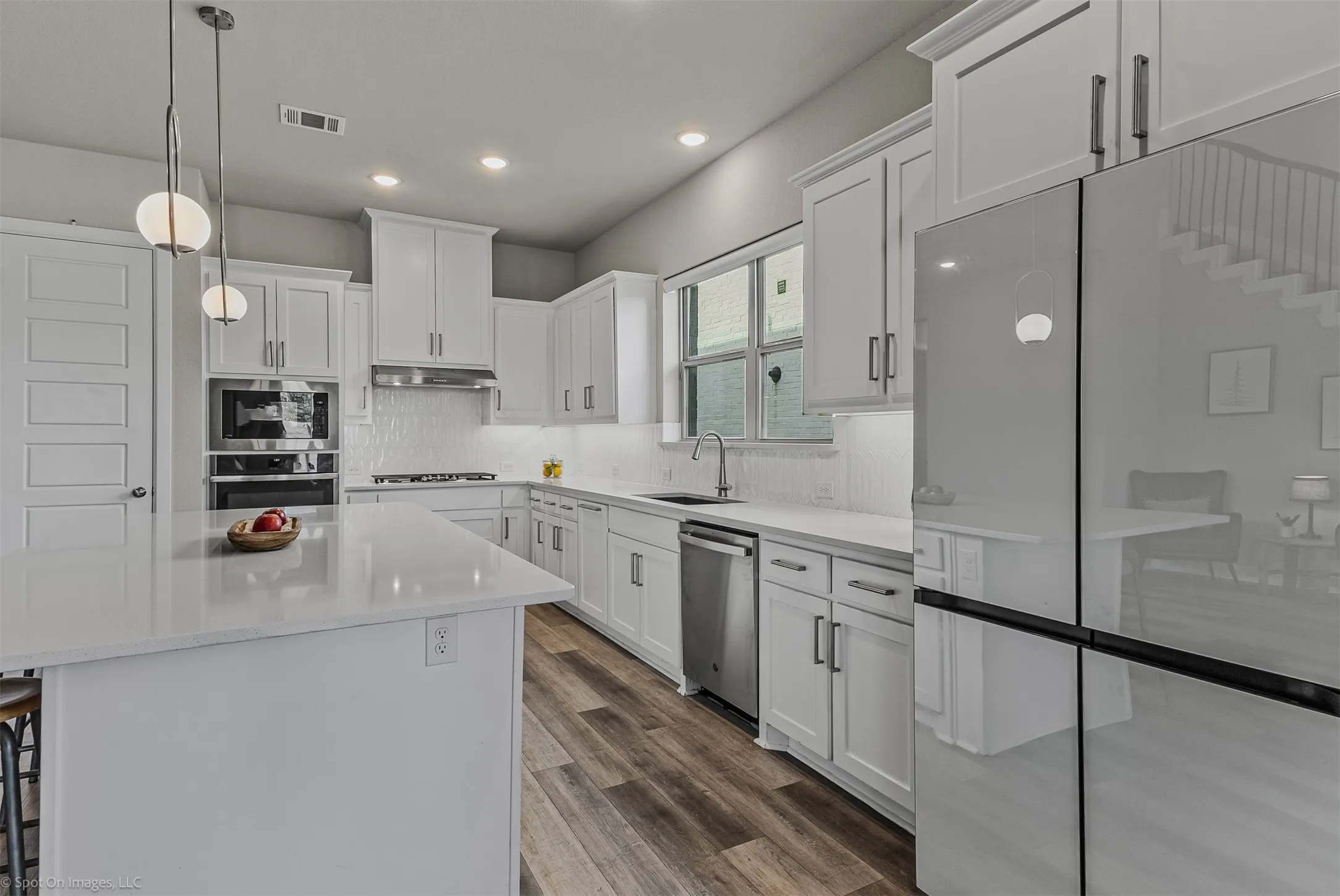 Large kitchen with white cabinets and countertops of 1302 20th St, Argyle, TX in Harvest by Hillwood