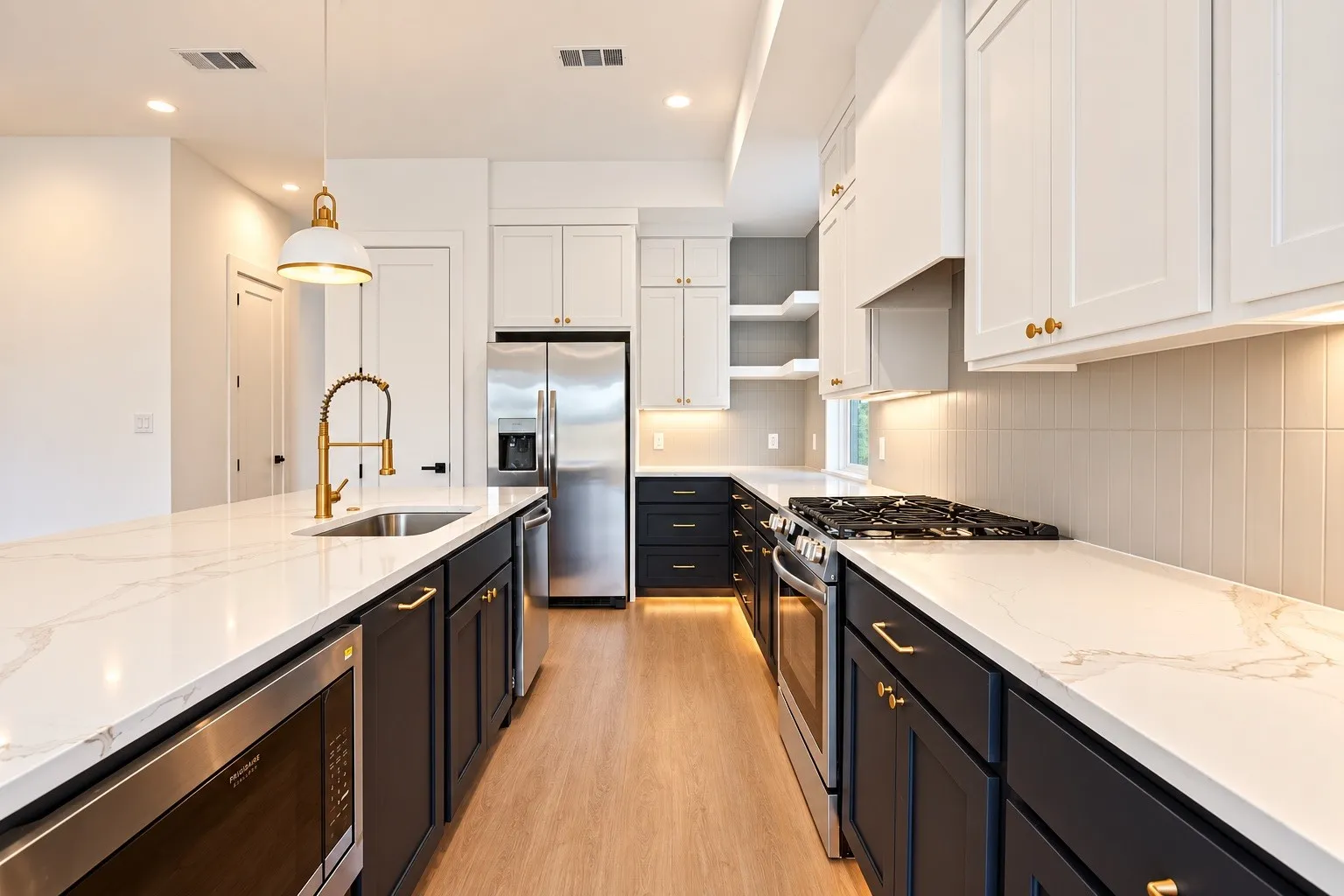 Kitchen featuring a dual-tone cabinetry scheme, stainless steel appliances, white countertops with veining, wood-finish flooring, and a subway tile backsplash