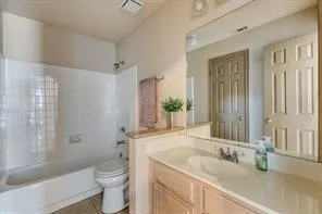 Built-in vanity with light-colored cabinetry and integrated sink