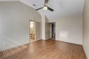 Vaulted ceiling, wood-finish flooring, ceiling fan, bi-fold door