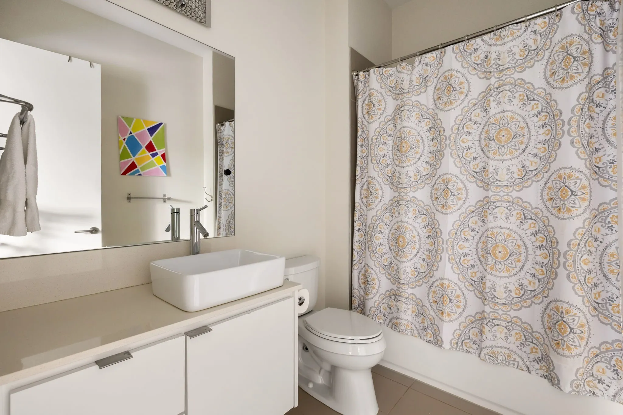 Floating vanity with a rectangular vessel sink, polished chrome faucet, and integrated mirror