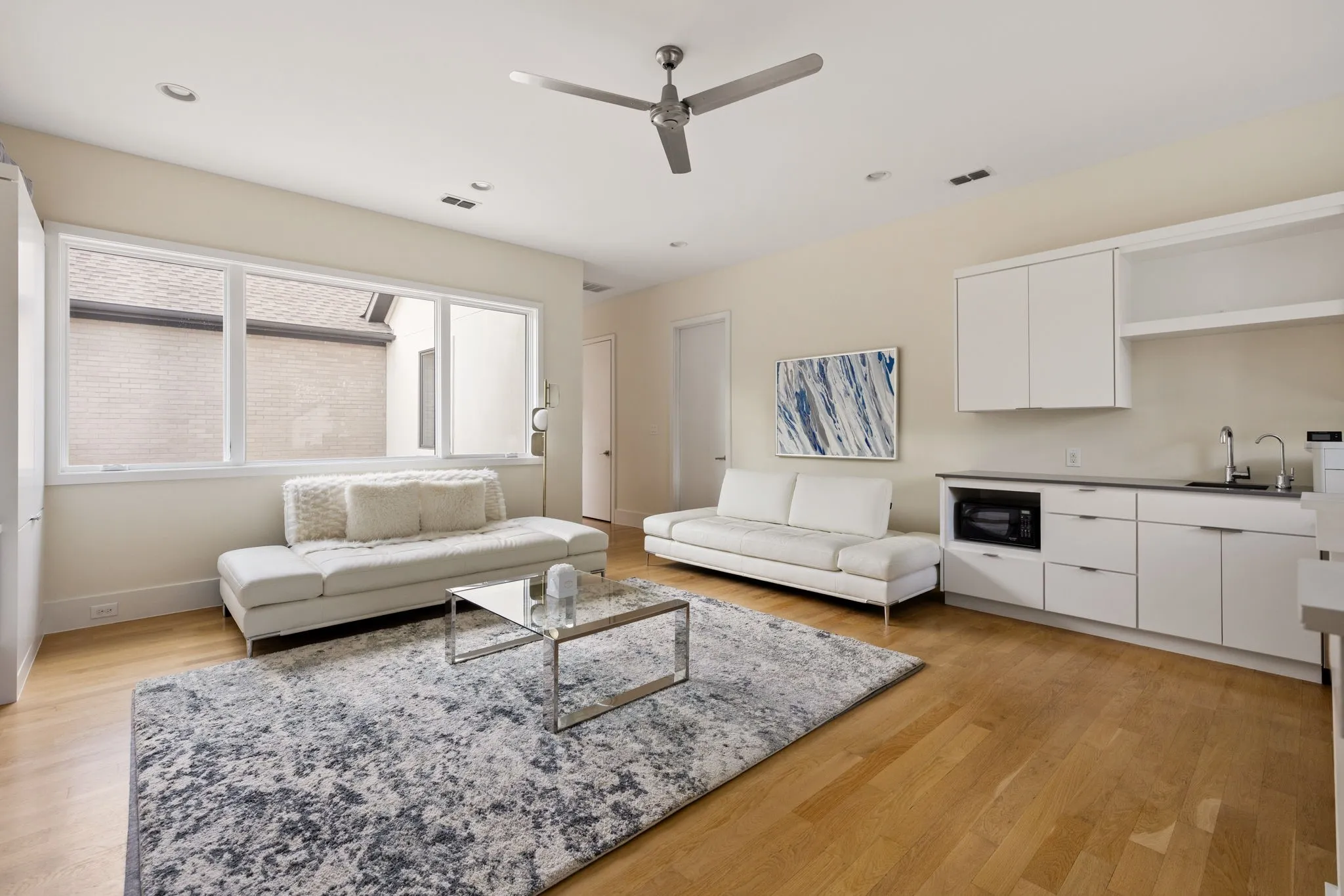 Wood-finish flooring, recessed lighting, and a modern ceiling fan
